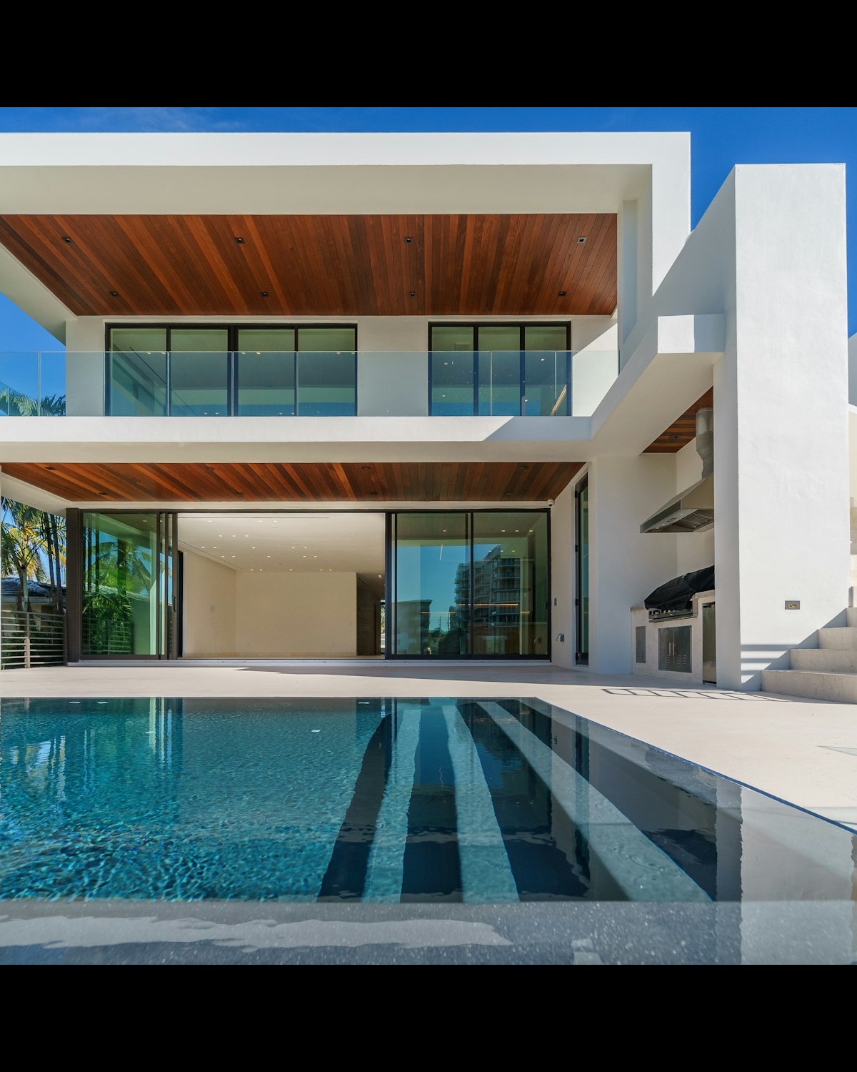 Residence at dusk, pool and glass