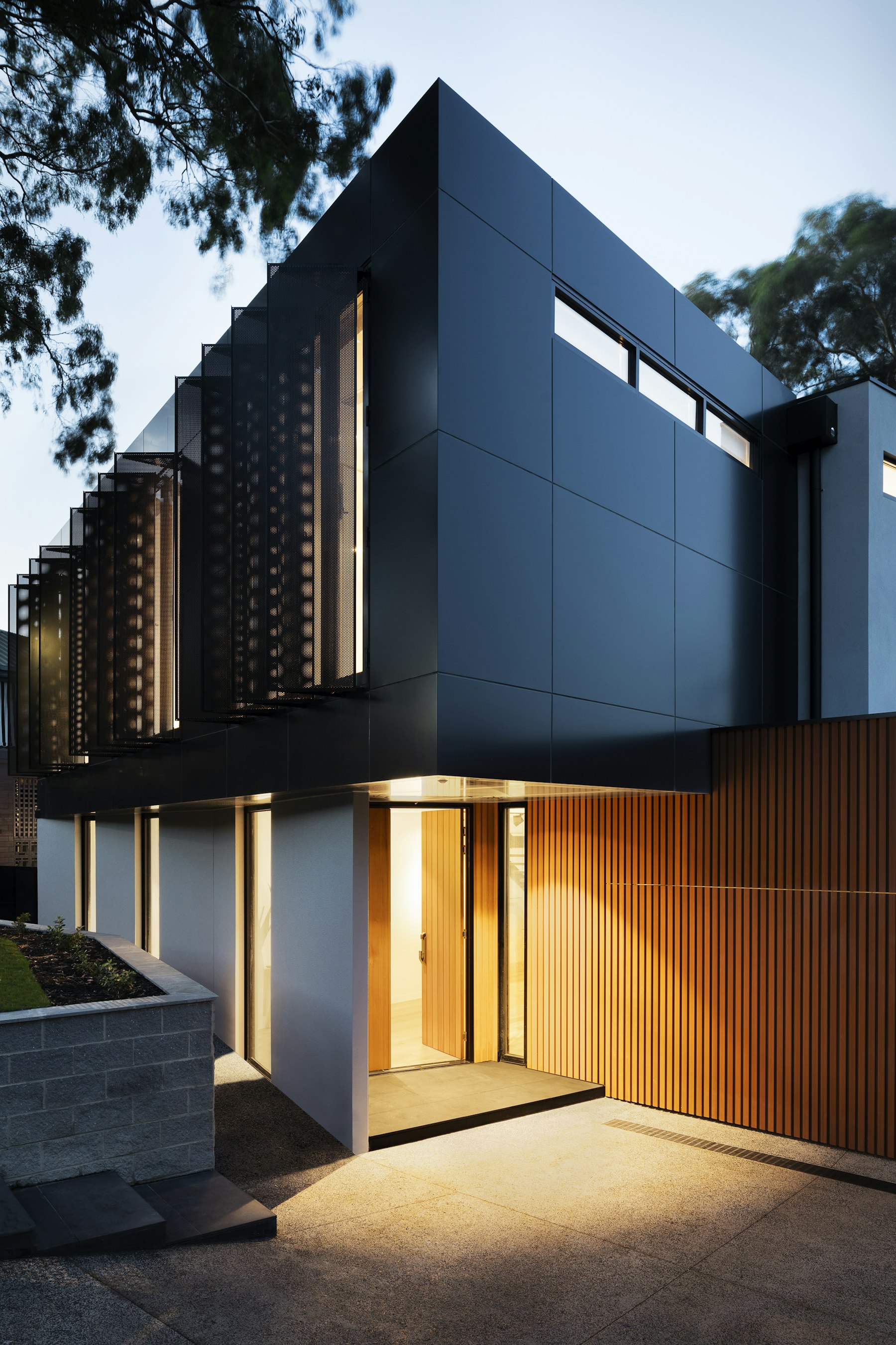 Wood-slat modern home at night