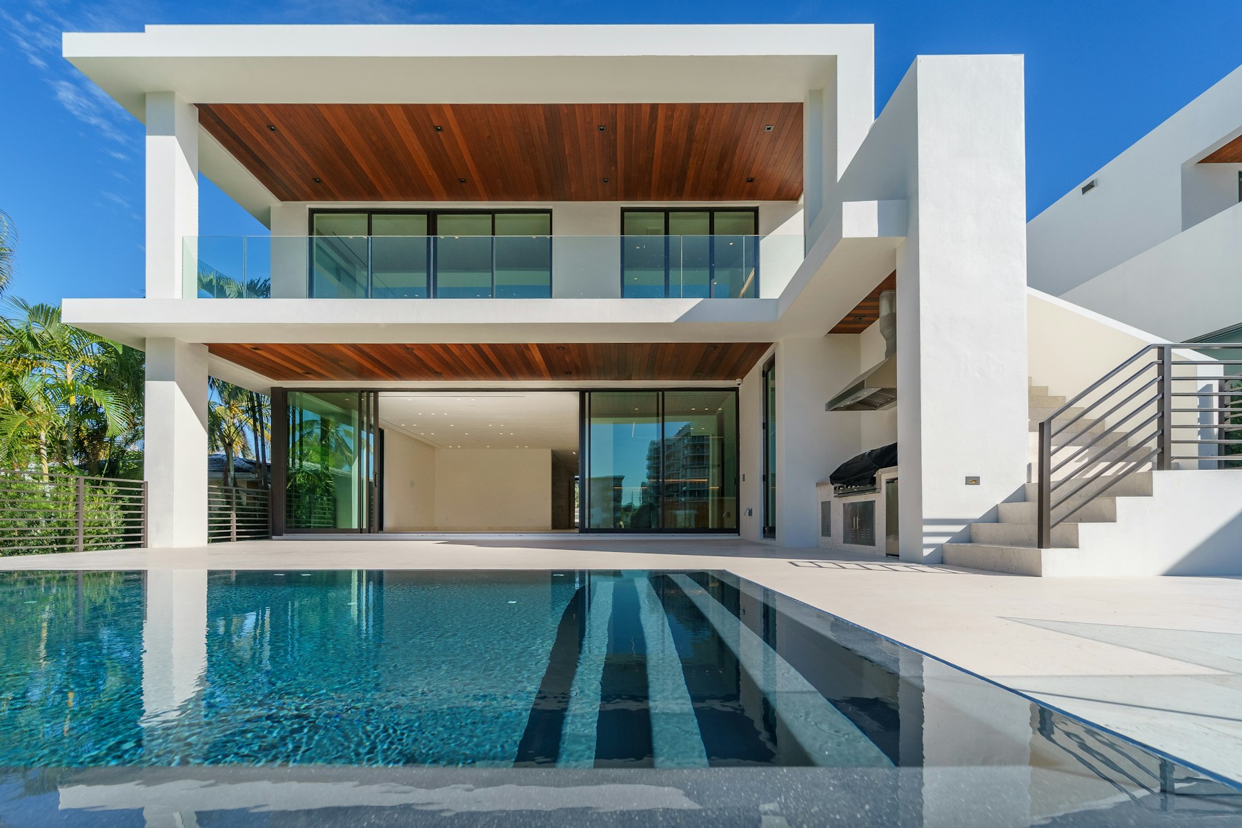 Two-story villa over pool at dusk