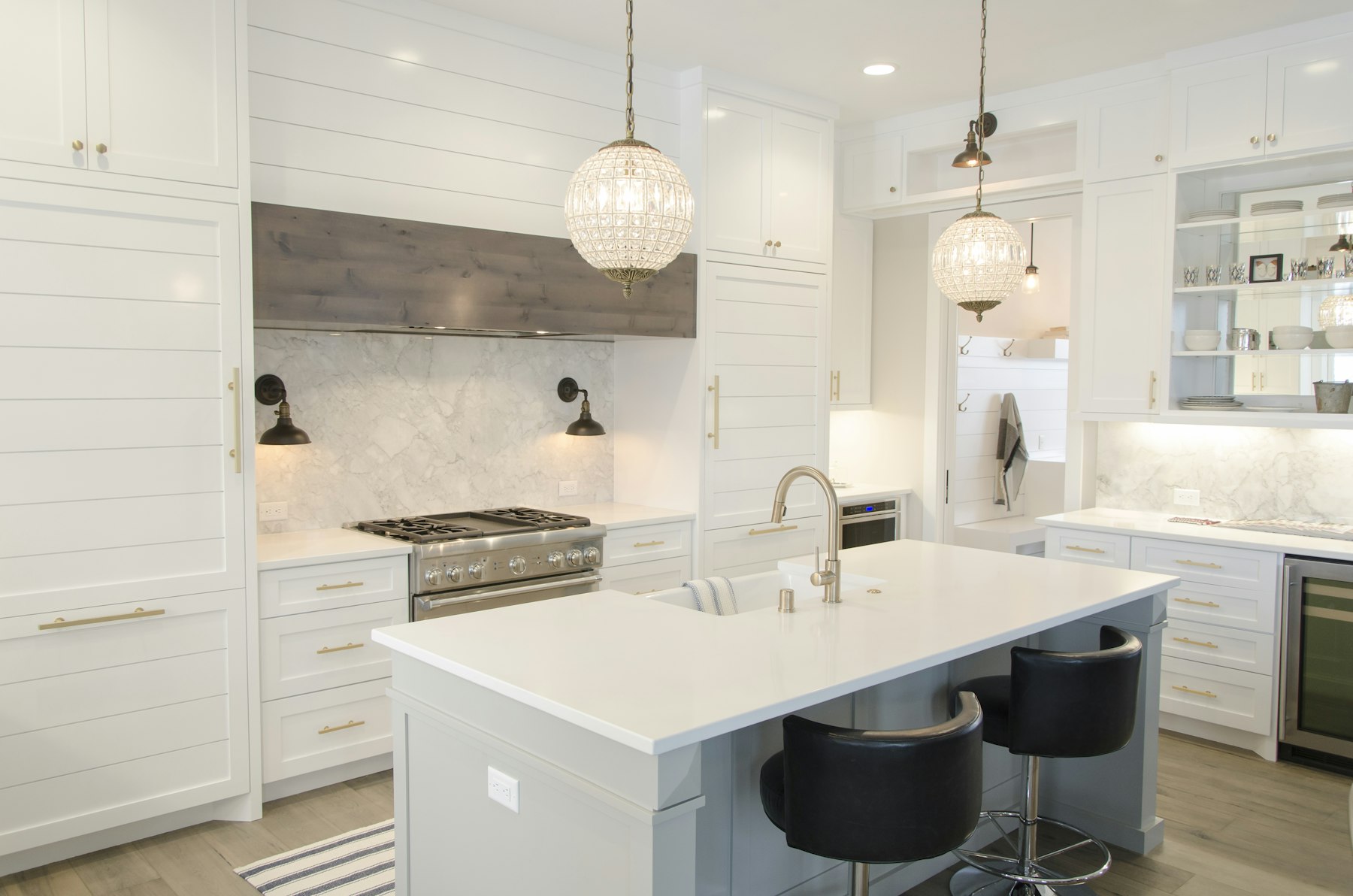 White kitchen with large island and pendants